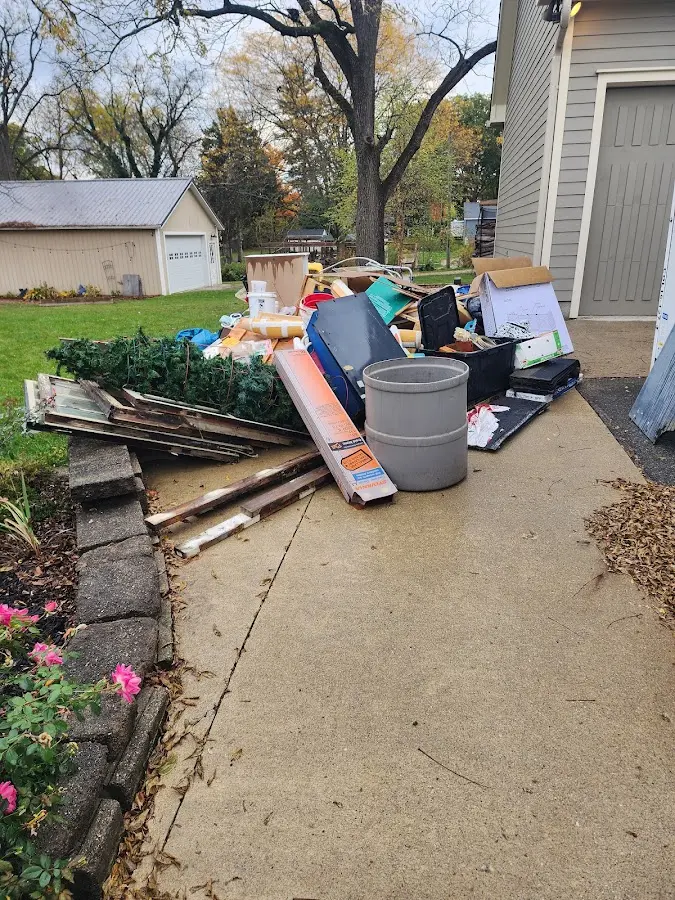 Dumpster being loaded with debris for Demolition Dumpster Rental in Westwood